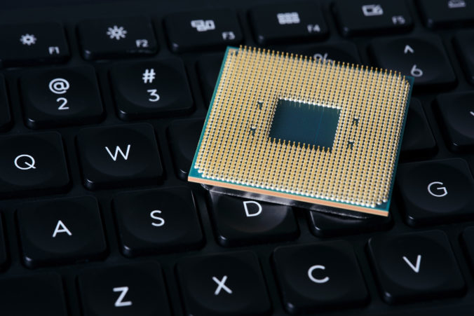 A close up of a CPU chip sitting on top of a keyboard